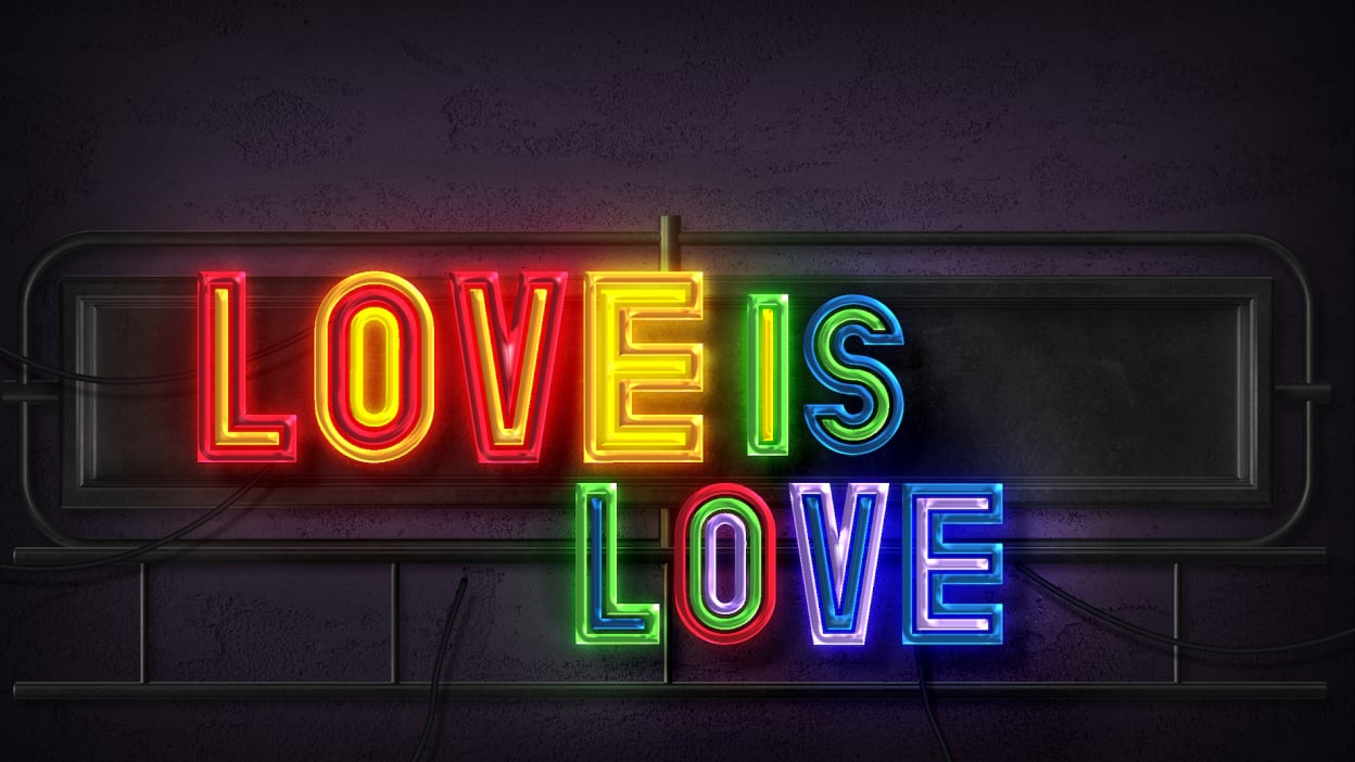 Love is love text in rainbow neon style on wall 
