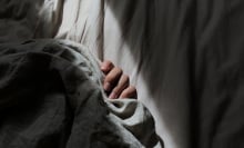 a person gripping on to bedsheets