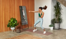 Woman doing a boxing workout in front of a smart mirror