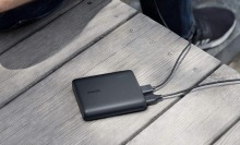 A black Anker Portable Charger on a table.