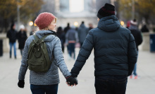 couple in winter coats hold hands 