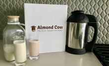 Almond cow milk maker next to glasses of non-dairy milk
