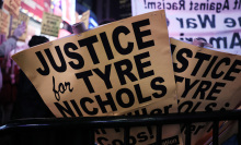 Protest signs are seen as people march on Broadway while protesting the death of Tyre Nichols on January 27, 2023 in New York City. 