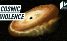A bright donut-shaped circle of light surrounds a black hole. Caption reads: Cosmic violence.
