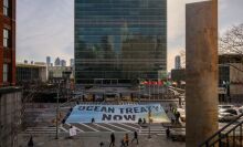 Activists from Greenpeace display a banner before the United Nations headquarters during ongoing negotiations at the UN on a treaty to protect the high seas in New York on February 27, 2023. 