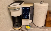 cream-colored single serve coffee maker with LED button panel