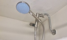 blue shower head connected to hose