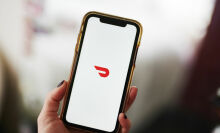 The DoorDash logo displayed on an Apple iPhone.
