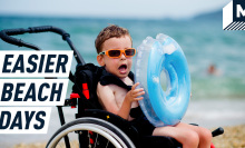 An excited young boy in a wheelchair holds an inflatable life belt. Caption reads: "Easier beach days"