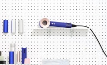 dyson supersonic on peg board among other supplies