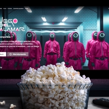 A tub of popcorn sits in front of a TV playing Netflix's "Squid Game."