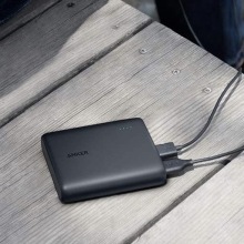 A black Anker Portable Charger on a table.