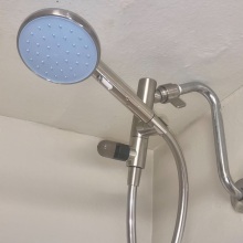 blue shower head connected to hose
