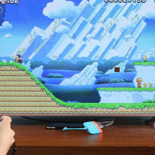 Two people playing nintendo switch on a TV