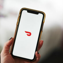 The DoorDash logo displayed on an Apple iPhone.