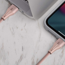 Pink lightning charging cable plugged into a tablet
