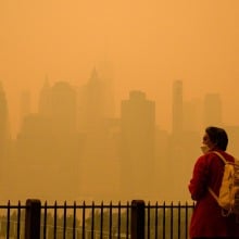 A person wears a face mask as smoke from wildfires in Canada cause hazy conditions in New York City