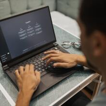 man using ChatGPT on a laptop