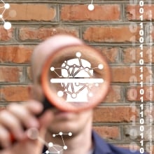 Man holding magnifying glass with digital illustration inside it