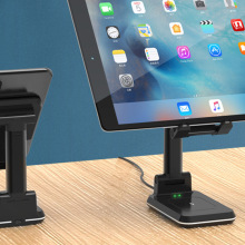 smartphone on one stand and a tablet on the other.