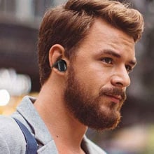 man wearing black bluetooth wireless earbuds