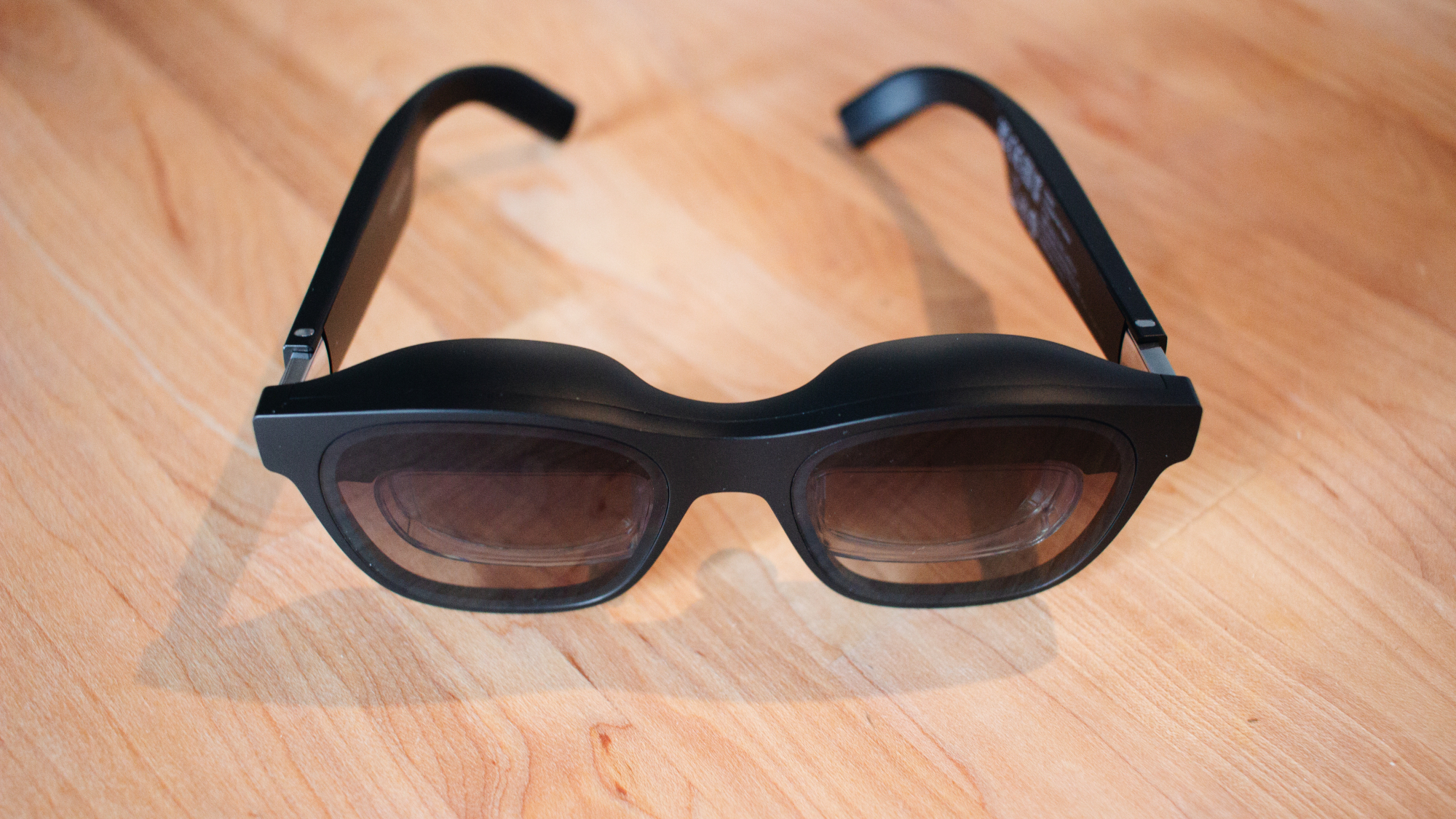 pair of tinted AR glasses with extra material to shade above the eyes