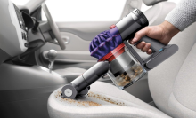  Dyson V7 Handheld Vacuum Cleaner cleaning a car.