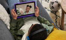 Children video calling on purple tablet