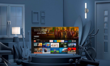an amazon omni series tv displaying the prime video interface in a grayscale living room