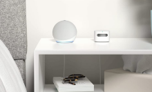 White echo dot sitting on a nightstand 