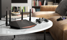 netgear router on table next to gaming controller