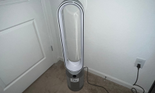 white and silver oblong dyson fan sitting in corner of a room
