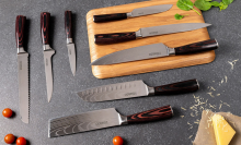 set of seido knives and cutting board laying on counter