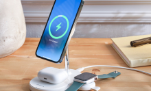 wireless charging station on desk charging iphone, apple watch, and airpods