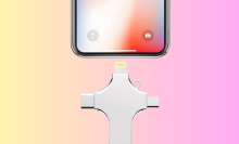 The 4-in-1 Smart Flash Drive near an iPhone overlaid on a colorful pink-and-yellow gradient background