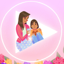 An illustration of a young woman and her mother sitting in a pink heart with flowers.