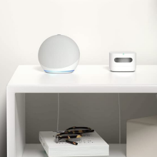 White echo dot sitting on a nightstand 