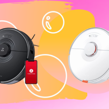 two robot vacuums: black on left, white on the right, against a pink background with peach shapes and bubble drawing