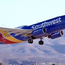 Southwest plane taking off with mountains in background