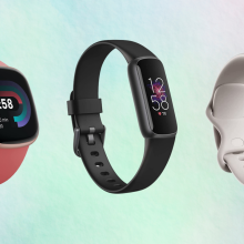 Fitbit fitness and wellness trackers against a colorful background