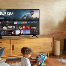 Woman and two children in a living room watching Jack Ryan on TV