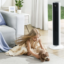 The LEVOIT Tower Fan in a room where a girl is playing with her stuffed bear next to a couch 