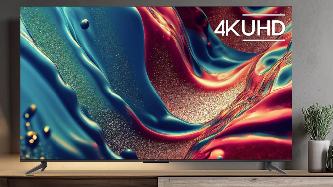 TCL TV with colorful abstract screensaver on wooden TV stand