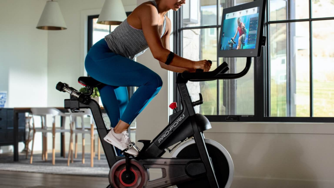 Person riding indoor cycling bike in home
