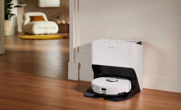 Roborock S8 Pro Ultra robot vacuum and dock against wall with furniture in background